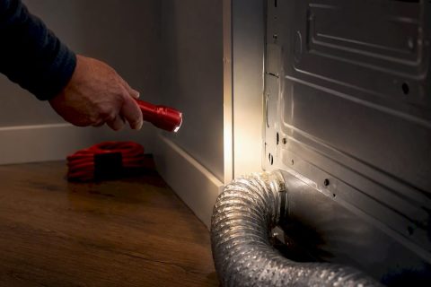 Flashlight inspecting dryer vent connection