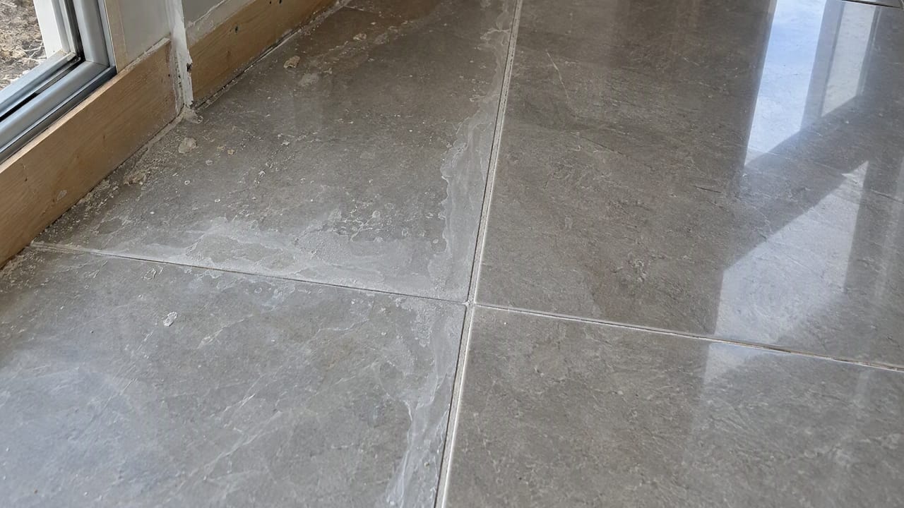 Epoxy haze film along porcelain grout joints