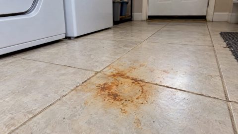 Orange rust stain on pale porcelain tile