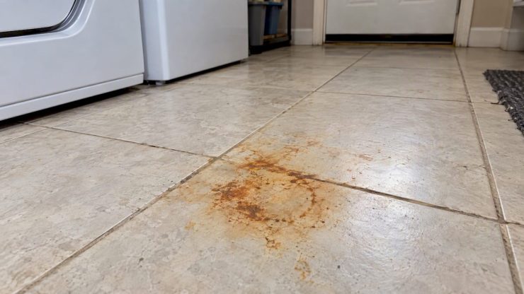 Orange rust stain on pale porcelain tile