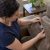 Homeowner checks care label on suede couch