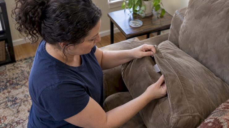 Homeowner checks care label on suede couch