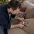Homeowner checks couch care tag beside ink stain